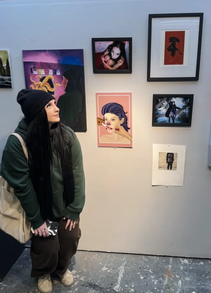 Hailea standing in front of her artwork at the 2024 Scholarship Award Show