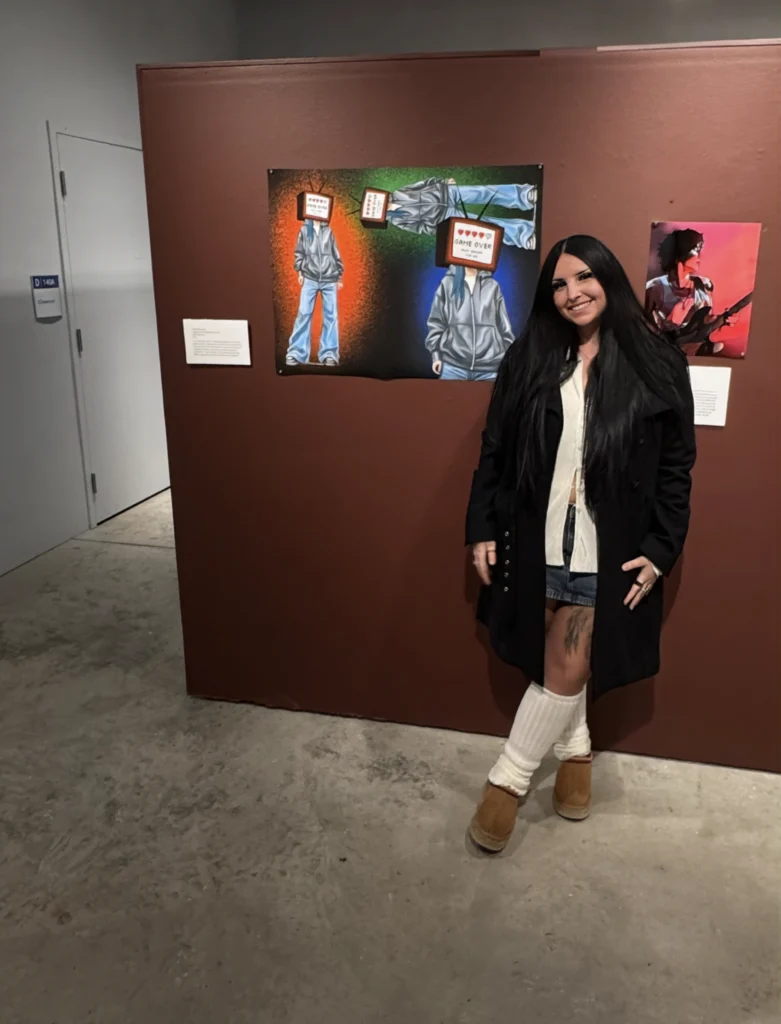 Hailea standing in front of her artwork at the 2025 